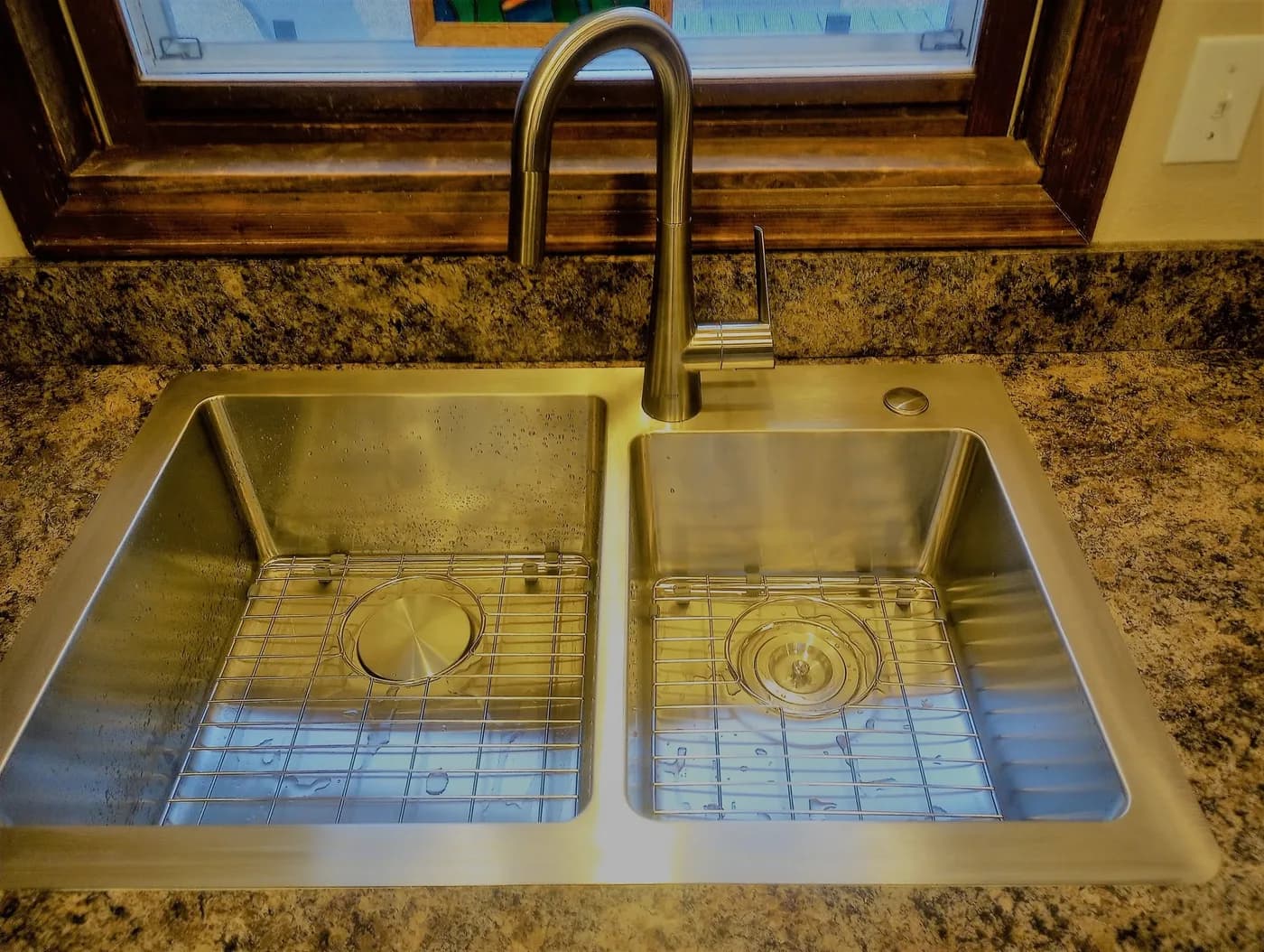 Double stainless kitchen sink with bronze faucet